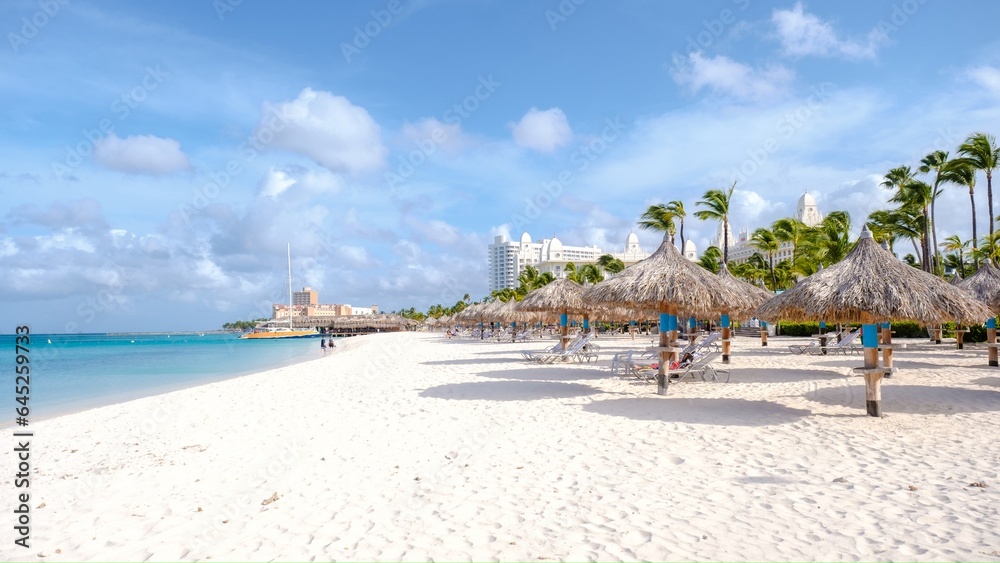 Palm Beach Aruba Caribbean, white long sandy beach with palm trees at Aruba Antilles.