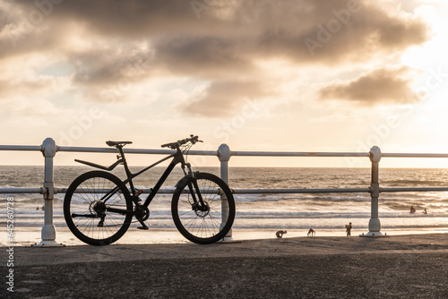 Silhouette of a bicycle in the sunset on the beach