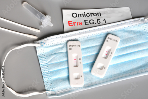 SARS-CoV-2 antigen test kit for self testing with positive result with text ERIS EG.5.1 on grey background. Concept for the new Covid 19 ERIS Variant