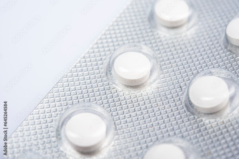 Macro shot of white pills` set isolated on white back-round Macro shot of white pills` set isolated on white back-round