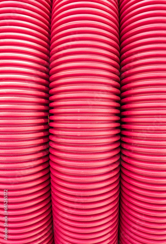 Background from detail of red plastic insulating pipes