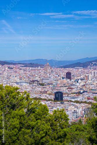 A view to the centre of Barcelona. Buildings and la sagrada familia in the distance. Beautiful mountains in background. High quality photo