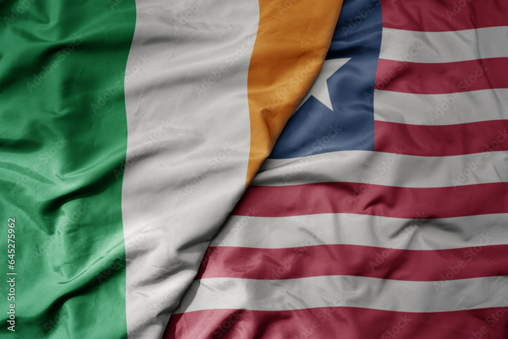 big waving national colorful flag of ireland and national flag of liberia . big waving national colorful flag of ireland and national flag of liberia .