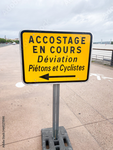 French "docking in progress, pedestrian and cyclist diversion" sign on the quays of Bordeaux, France