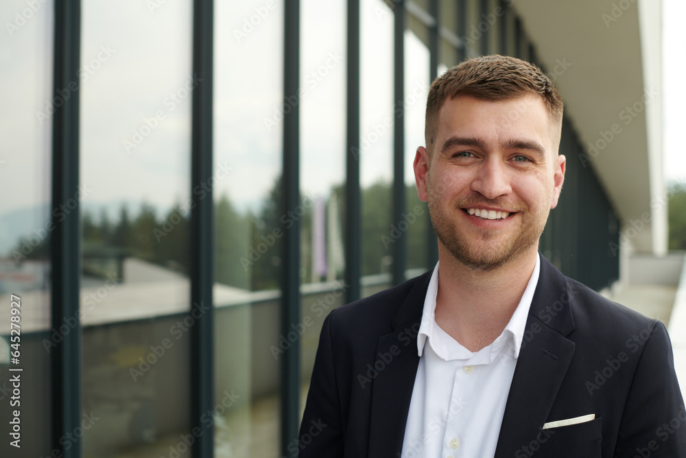 A CEO dressed in a sleek black suit stands confidently at the entrance of a modern corporate building, awaiting the start of the workday in the bustling urban environment. A CEO dressed in a sleek black suit stands confidently at the entrance of a modern corporate building, awaiting the start of the workday in the bustling urban environment.