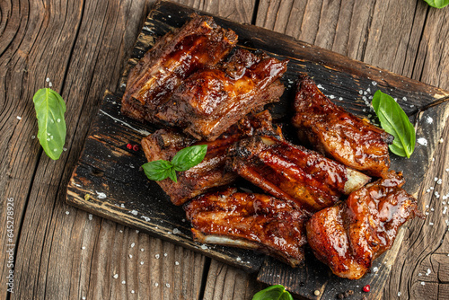 Grilled ribs on cutting board. Restaurant menu, dieting, cookbook recipe top view