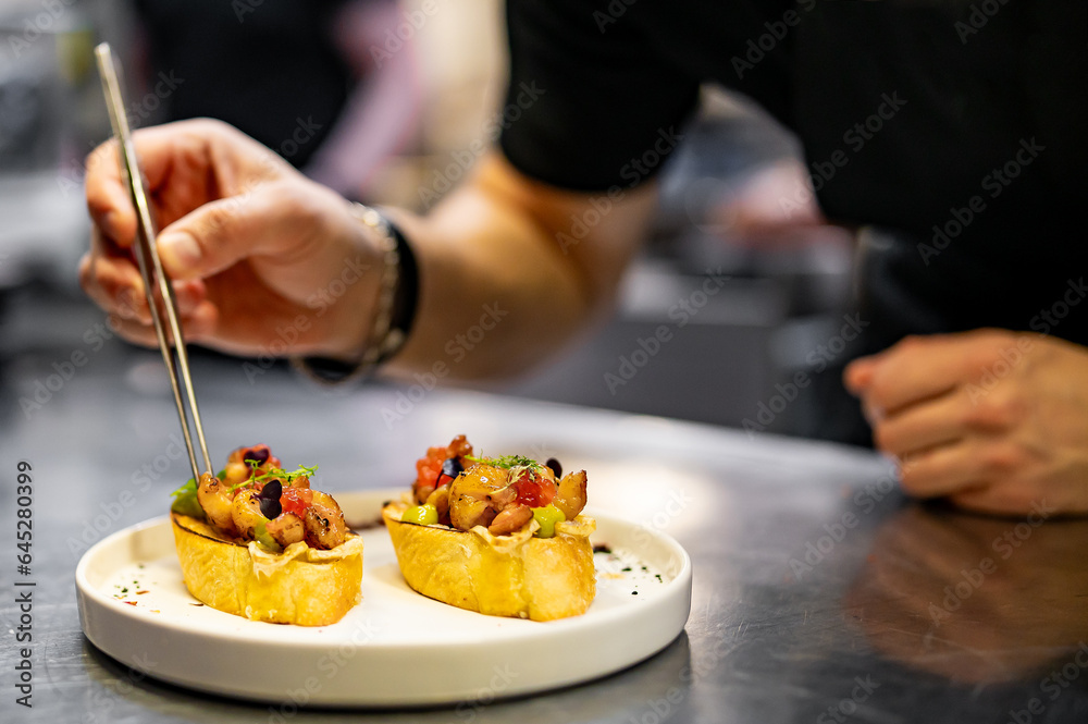 chef hand cooking Prawns, shrimp seafood bruschetta with creamy cheese on restaurant kitchen