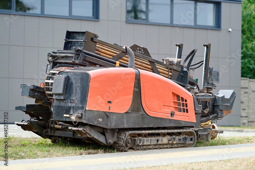 Directional drill machine, drilling technology. Horizontal directional drilling machine, HDD drill rig. Drilling rig stands on sidewalk. Trenchless installing underground utilities - pipe or cables