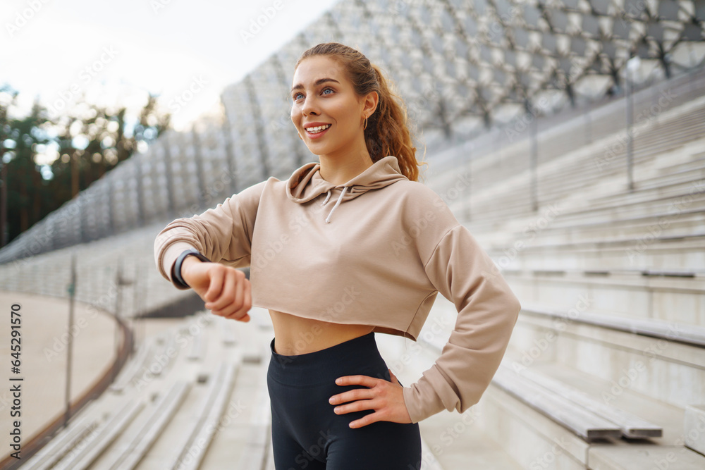 Fitness woman doing sports outdoors in an urban environment. A sports woman in special clothes does exercises. Active lifestyle, training. Lifestyle. Fitness woman doing sports outdoors in an urban environment. A sports woman in special clothes does exercises. Active lifestyle, training. Lifestyle.