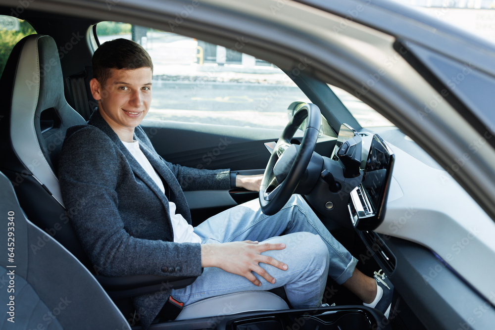 Attractive elegant happy man in good car. Confident businessman driving an expensive car and loking at camera. Attractive elegant happy man in good car. Confident businessman driving an expensive car and loking at camera.