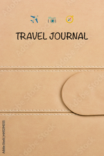 close-up of a travel journal cover featuring three small logos: a plane, a camera, and a compass. The logos add a touch of adventure and exploration to this beautifully crafted journal