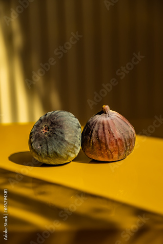 Black fig fruit with yellow background