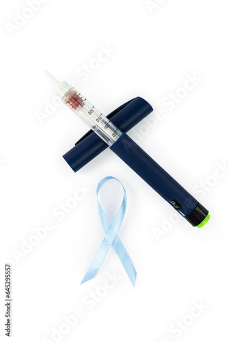 Insulin syringe pen with needle to fight diabetes and blue ribbon isolated on white background