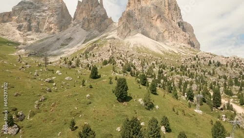 FPV drone heads to Italian Dolomites' Sasslong mountain, soaring above rock formations and an old cable car on its ascent. A mesmerizing journey awaits. LuPa Creative. photo