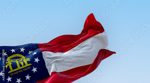The state flag of Georgia waving in the wind on a clear day