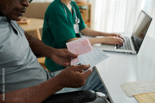 Man with disability asking social worker to help him with medical documents