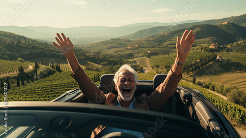 Handsome senior man enjoying car ride in Toscana