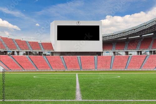 Football field with large LED screen in stadium with empty seats, scoreboard.