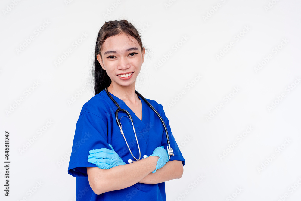 A joyful and smiling medical student or nurse or intern posing with her arms folded while wearing gloves. Isolated on a white background. A joyful and smiling medical student or nurse or intern posing with her arms folded while wearing gloves. Isolated on a white background.