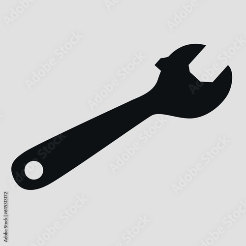Silhouette of an adjustable wrench. Vector on a gray background.