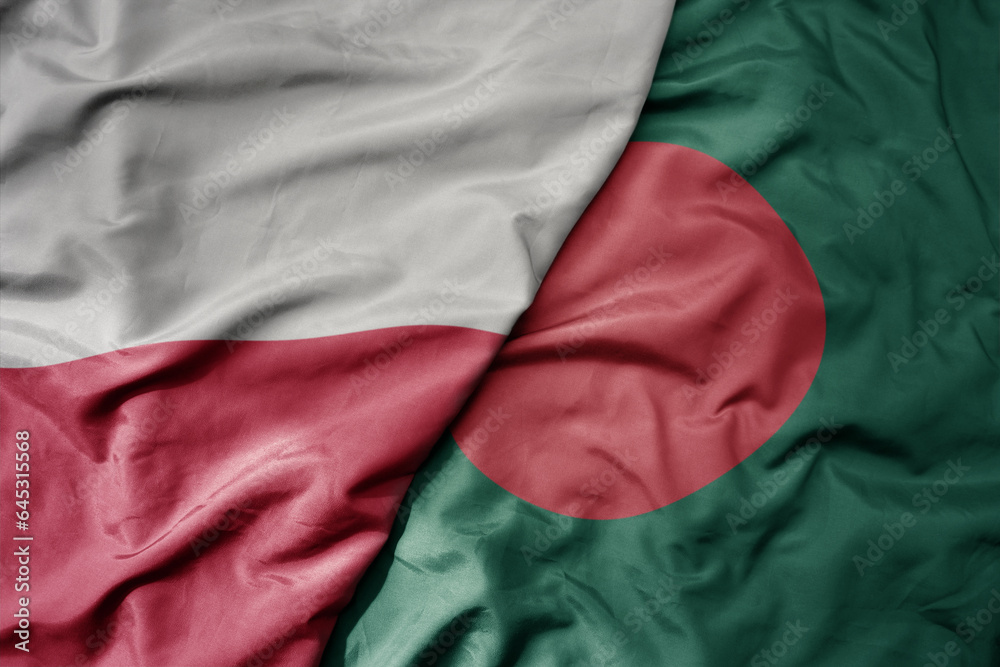 big waving national colorful flag of poland and national flag of bangladesh .