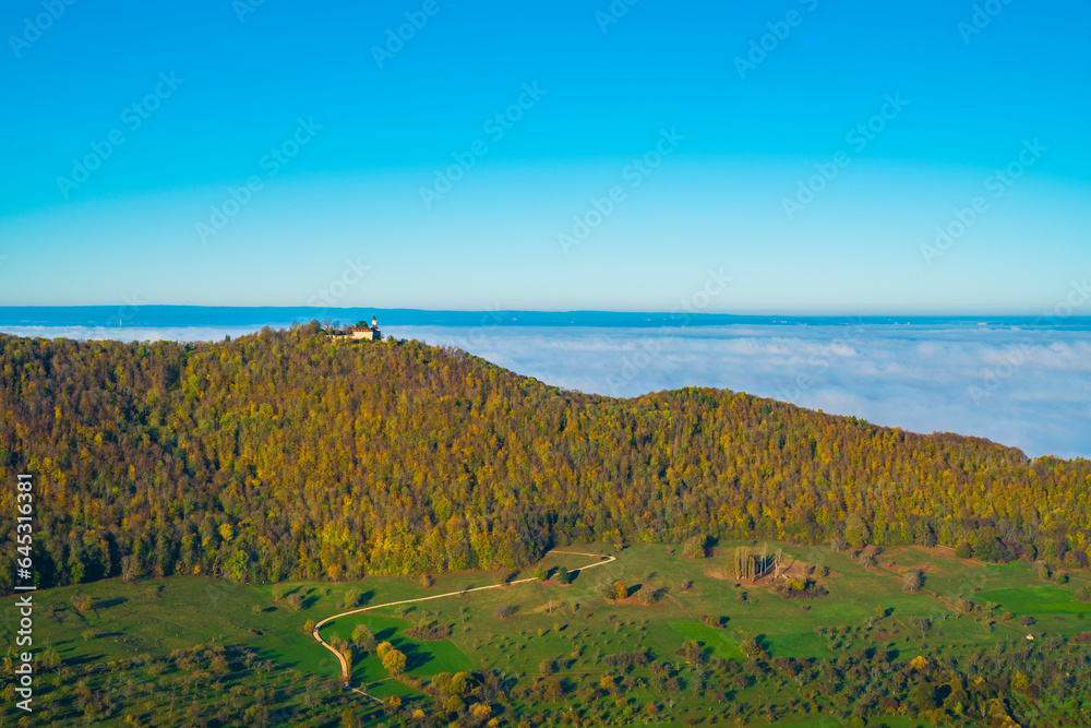 Germany, Ancient beautiful castle teck aerial panorama view above foggy nature landscape trees valley early morning at sunrise in autumn