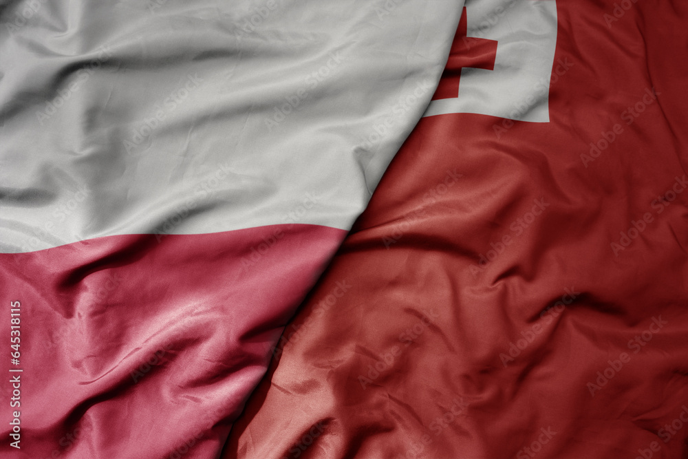 big waving national colorful flag of poland and national flag of Tonga . big waving national colorful flag of poland and national flag of Tonga .
