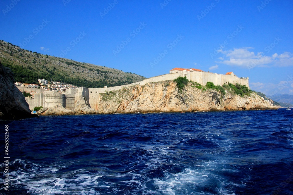 
View of Dubrovnik West Harbor and the ancient city wall during summer, blue Adriatic sea water on foreground