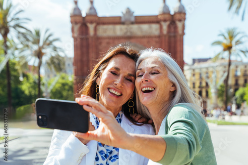 Canvas Print Beautiful senior women meeting outdoors in the city - Two mature female adults f