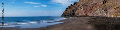 Panoramic view of Las Gaviotas playa, Canary Islands beach with black volcanic sand located at the foot of a cliff