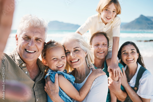 Family, grandparents and children in beach selfie, portrait or parents for love, sunshine or memory on holiday. Men, women and kids by sea, happy and update on social network post for summer in Spain