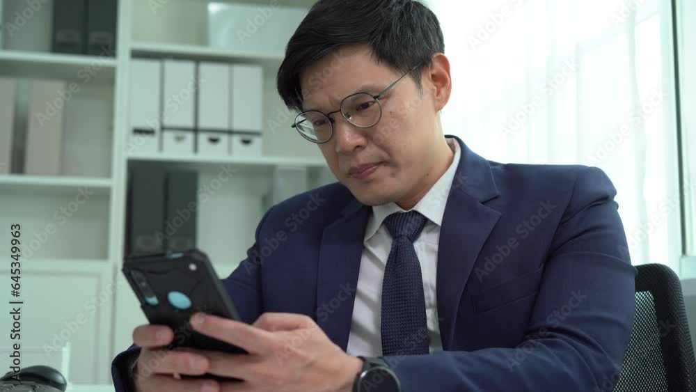 serious asian business man in suit using computer on desk suffering eye strain pain took off glasses and holding glasses and rubbing eyes . Tired exhausted worker eyes closed to rest in office . serious asian business man in suit using computer on desk suffering eye strain pain took off glasses and holding glasses and rubbing eyes . Tired exhausted worker eyes closed to rest in office .
