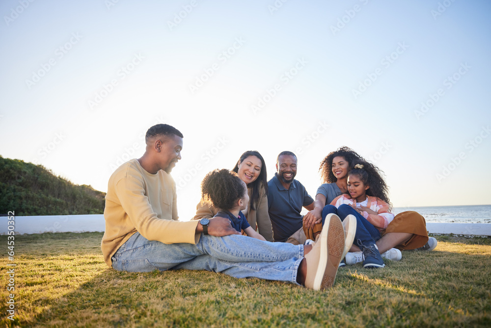 Beach, happy and family relax on vacation, bonding and having fun together on grass on mockup space. Grandparents, smile and interracial parents with kids at ocean to travel on holiday, care and love Beach, happy and family relax on vacation, bonding and having fun together on grass on mockup space. Grandparents, smile and interracial parents with kids at ocean to travel on holiday, care and love