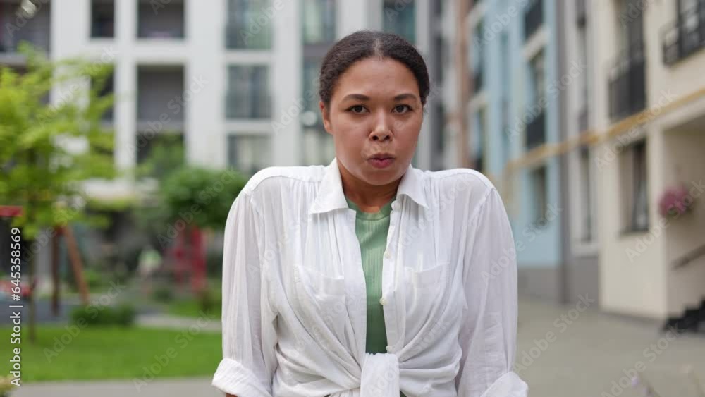 Distressed African American Woman Outside, Displaying Signs of Anger and Frustration. Lady with Bipolar Disorder and Depression Shouting Outdoors. People and Emotions Concept Distressed African American Woman Outside, Displaying Signs of Anger and Frustration. Lady with Bipolar Disorder and Depression Shouting Outdoors. People and Emotions Concept