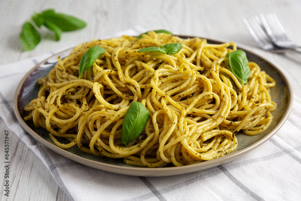 Homemade Vegan Pesto Pasta on a Plate, side view. Close-up. Homemade Vegan Pesto Pasta on a Plate, side view. Close-up.