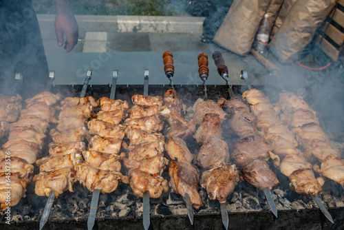 Photography meat on skewers is cooked on coals in the grill.