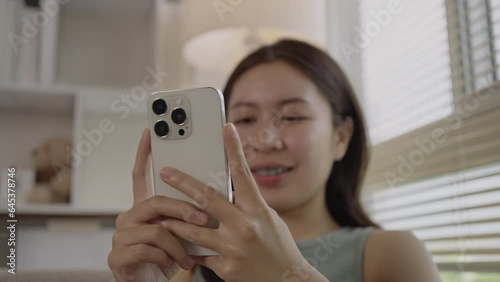 Young Woman in Happy Conversation with Friends on Smartphone, Smiling Woman Engages in Joyful Phone Chat, Digital Connection, Modern Communication.