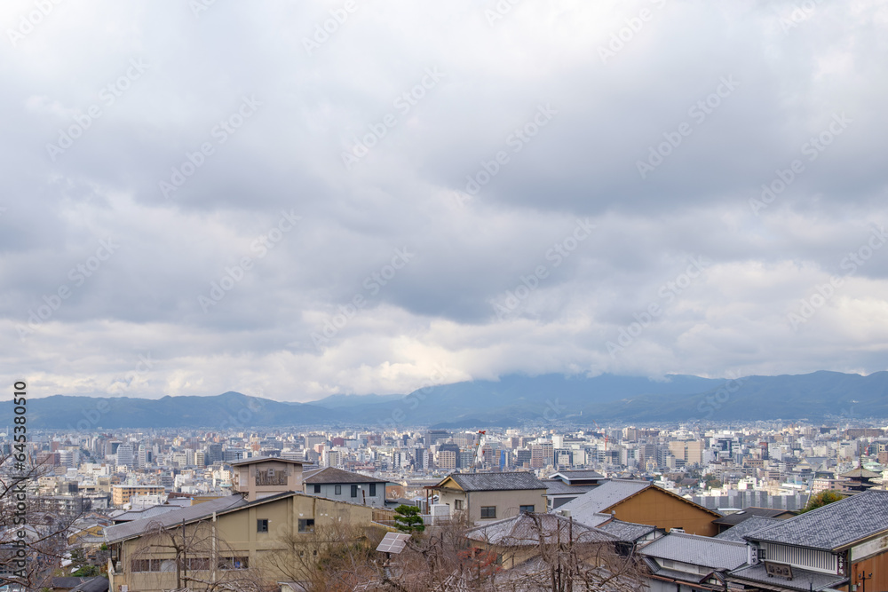 The distant mountains provide a sense of grandeur and tranquility view of the heart of Kyoto.