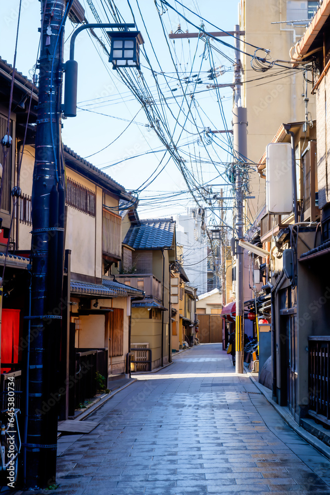 Fototapeta premium the serene ambiance of a local Japanese alley in Kyoto during the early morning hours.