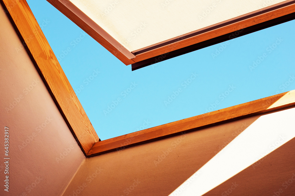 Fototapeta premium Open skylight with a piece of blue sky
