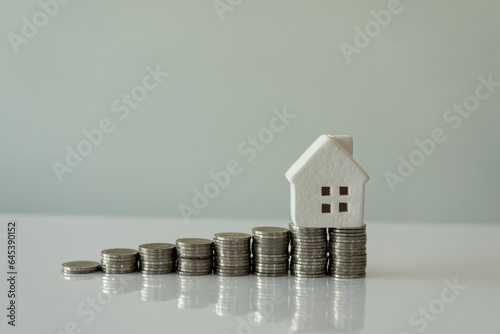 Photography Interest Rates for Home Business and Home Savings for Home Ideas Added stacked coins and house models on the table, money management for loans, real estate prices increased