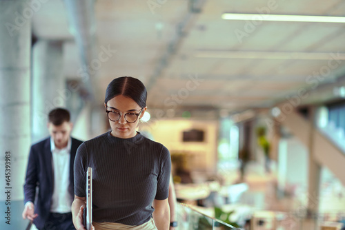 In the modern corporate world, a diverse group of businesspeople, representing various backgrounds and cultures, briskly walks through the hallway of a cutting-edge startup office, exemplifying