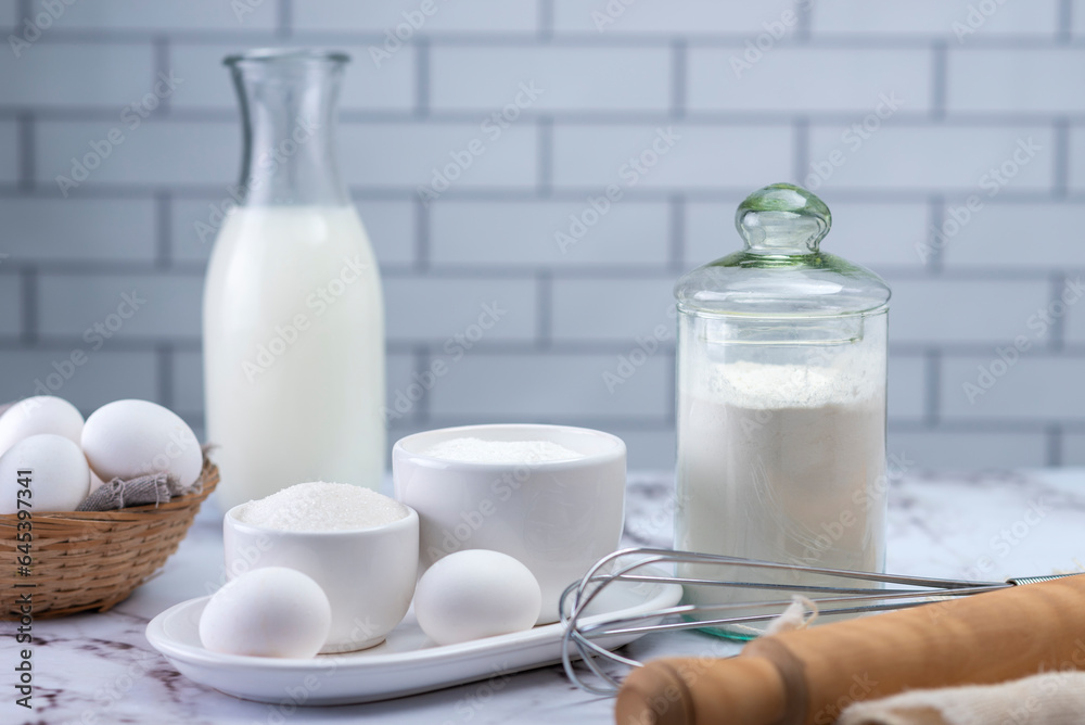 mise en place sugar ingredients coconut flour milk whisk and kneading stick and eggs with white batter mise en place sugar ingredients coconut flour milk whisk and kneading stick and eggs with white batter