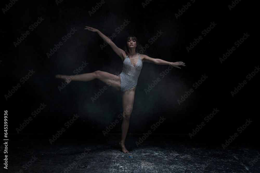 ballet dancer posing. ballet dancer in black. woman dancing in the dark. woman dancing in studio. woman dancing.