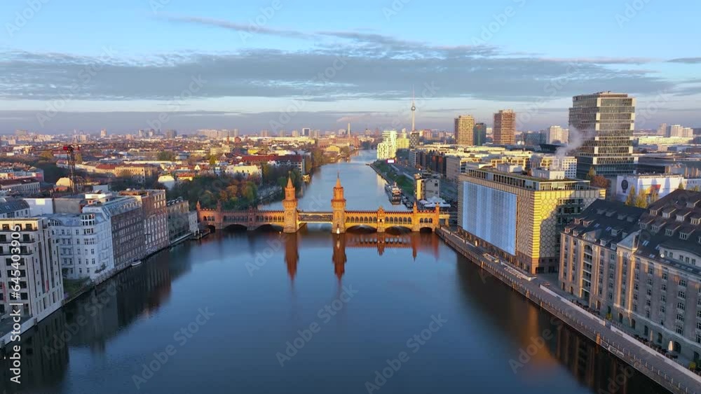 City of Berlin, Germany from above. Aerial cityscape view showing architectural landmarks Oberbaum Bridge, TV Tower and Berlin Cathedral at sunrise. Drone flight on the river Spree. City of Berlin, Germany from above. Aerial cityscape view showing architectural landmarks Oberbaum Bridge, TV Tower and Berlin Cathedral at sunrise. Drone flight on the river Spree.