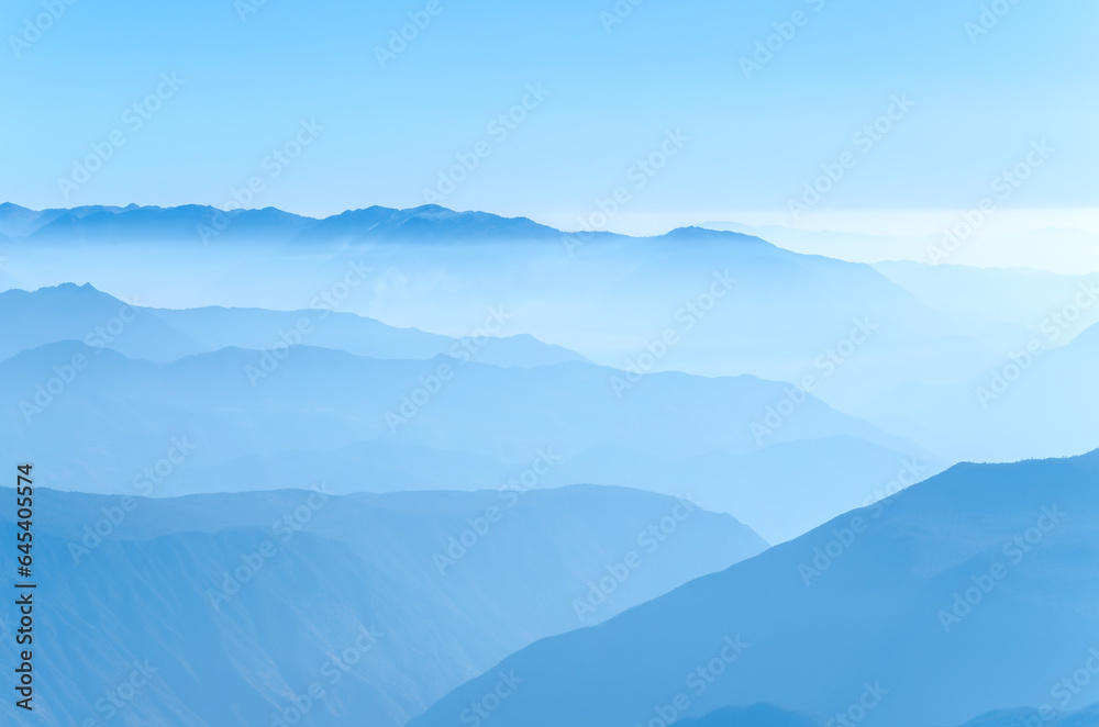 Mountains with cloud and fog in morning. Blue color mountain abstract background.