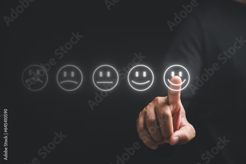 Close up of a finger man's hand touching provide positive feedback for excellent service. Concept of business satisfaction survey and digital technology, smile face for good service