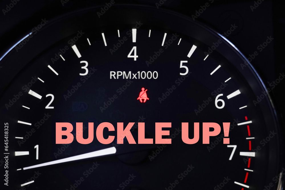 Orange fasten seat beat indicator light on dashboard with reminder message. Orange fasten seat beat indicator light on dashboard with reminder message.
