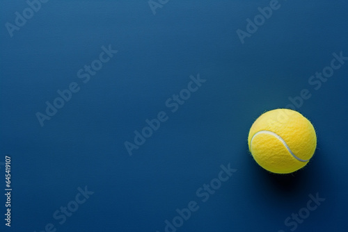 The tennis ball on a blue surface for mock up, backdrop, presentation.  © Andrey Tarakanov