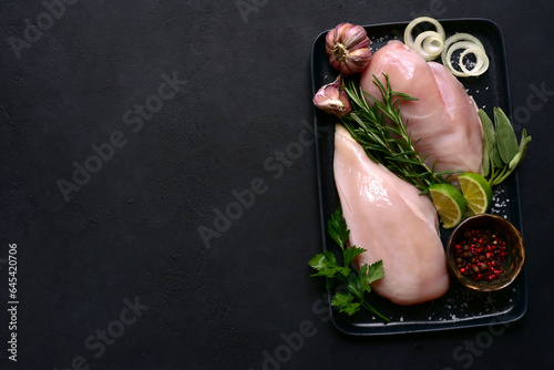 Fresh organic chiken fillet with spices. Top view with copy space.